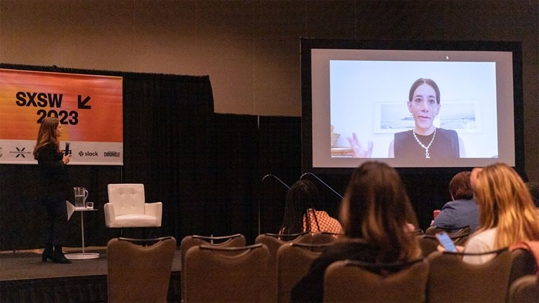 Sarah presenting on stage